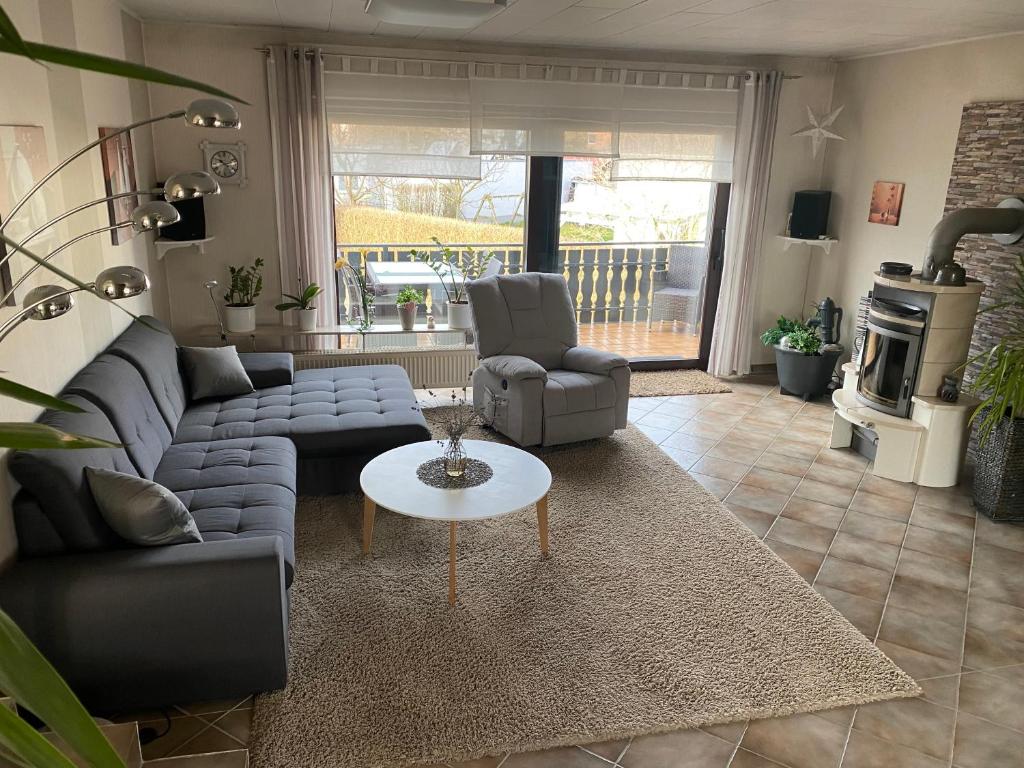 a living room with a couch and a table at Ferienwohnung Maifeldtraum in Mertloch