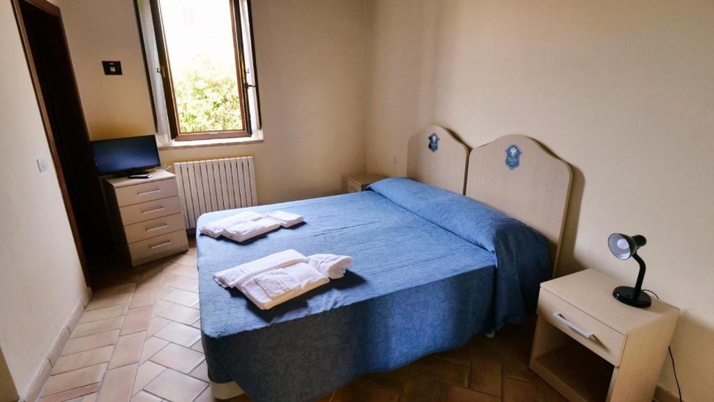 Postel nebo postele na pokoji v ubytování Borgo de' Varano by Hotel I Duchi
