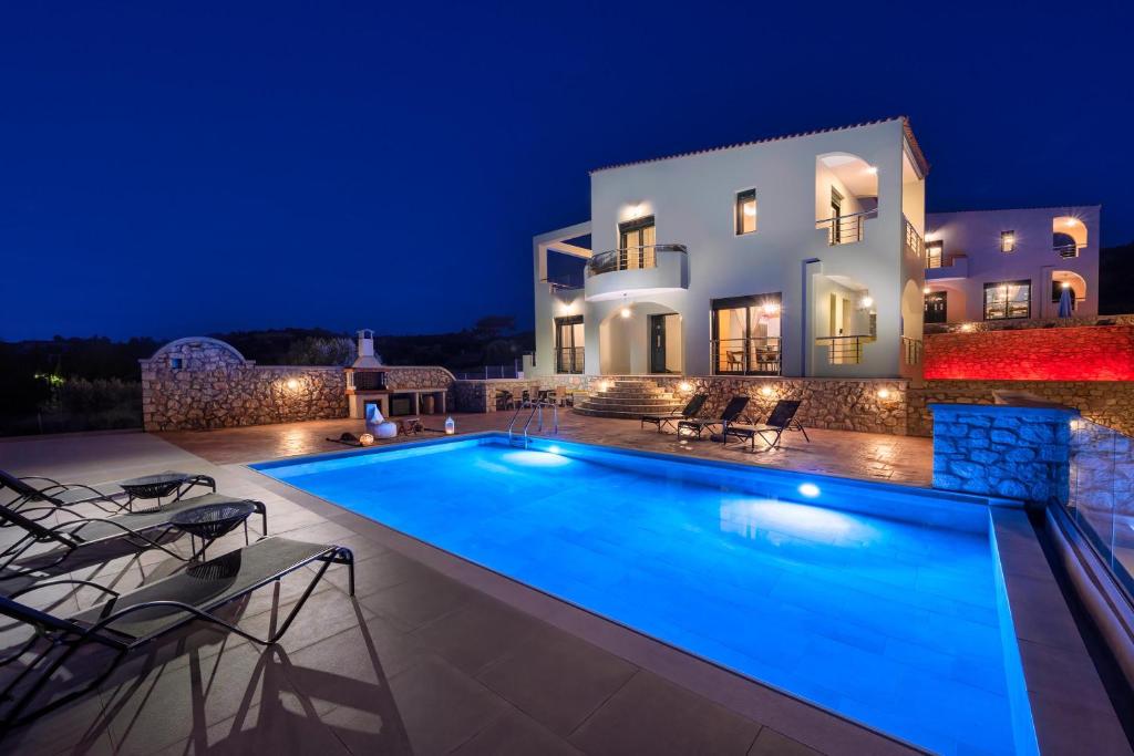 uma villa com piscina à noite em Alki Slow Living em Afantou