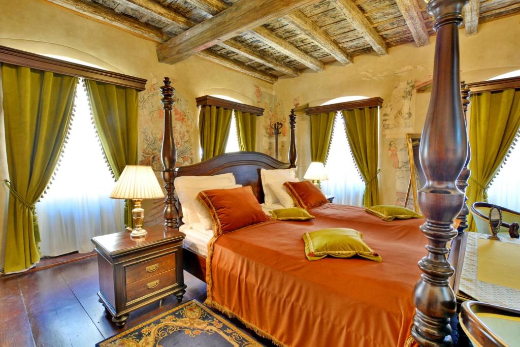 a bedroom with a large bed with orange sheets at Casa Georgius Krauss Sighisoara in Sighişoara