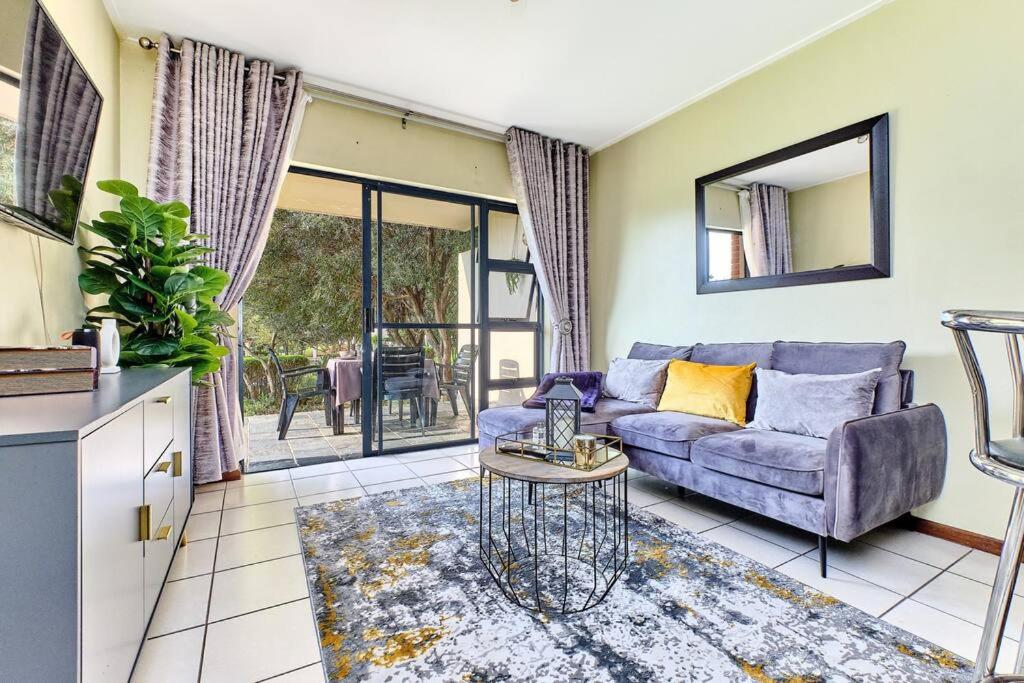 a living room with a couch and a table at Estate Lifestyle+Inverter+Wi-Fi in Roodepoort