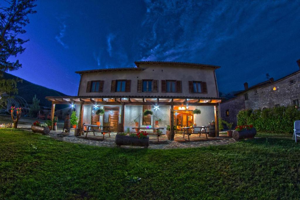 a house with lights on the front of it at night at Agriturismo La Fattoria in Norcia