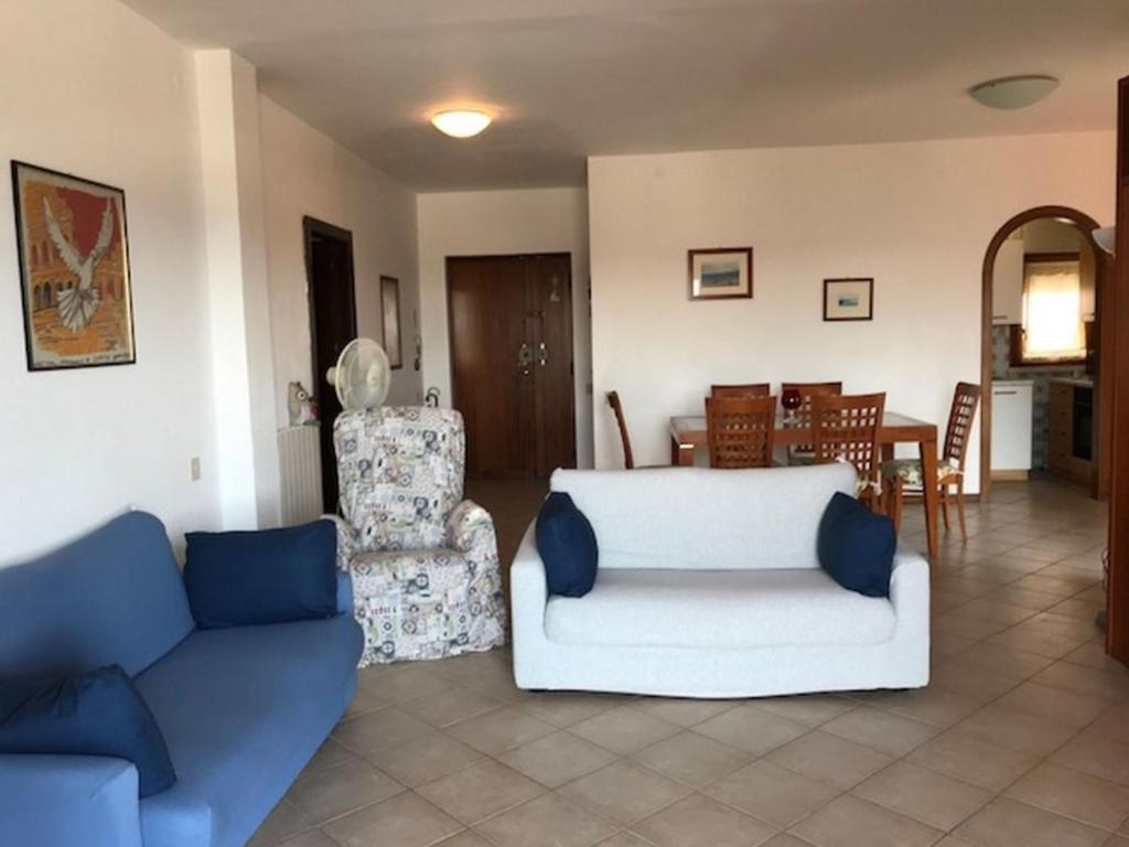a living room with two couches and a dining room at Appartamento FAB in Follonica