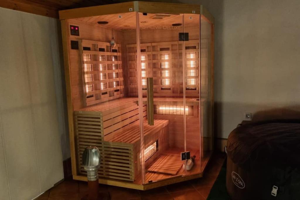 a large glass shower in a room with a bed at Santiago del Teide Apartman in Santiago del Teide