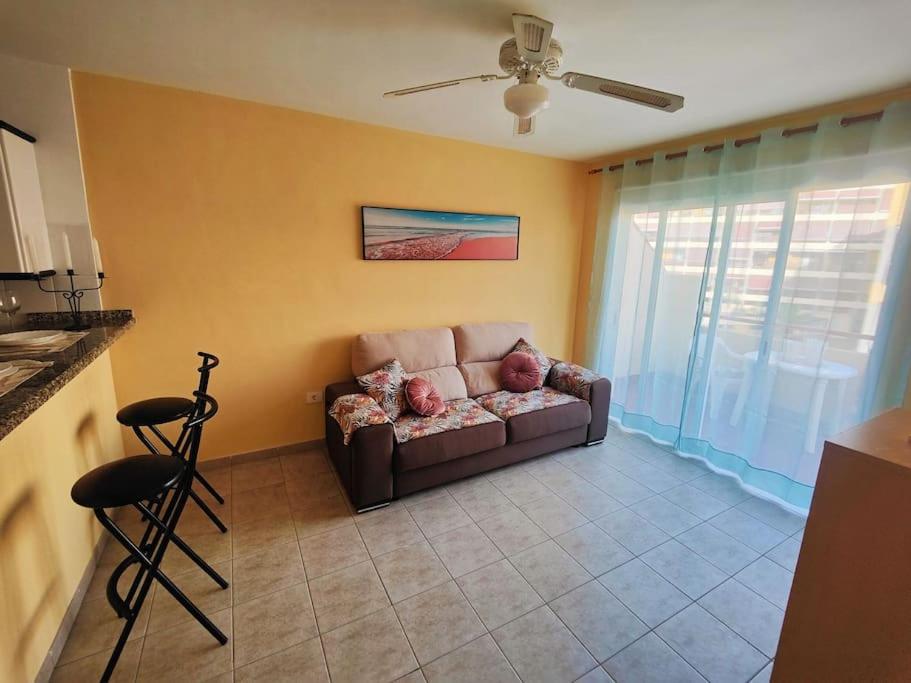 a living room with a couch and a ceiling fan at sol y mar in Puerto de Santiago