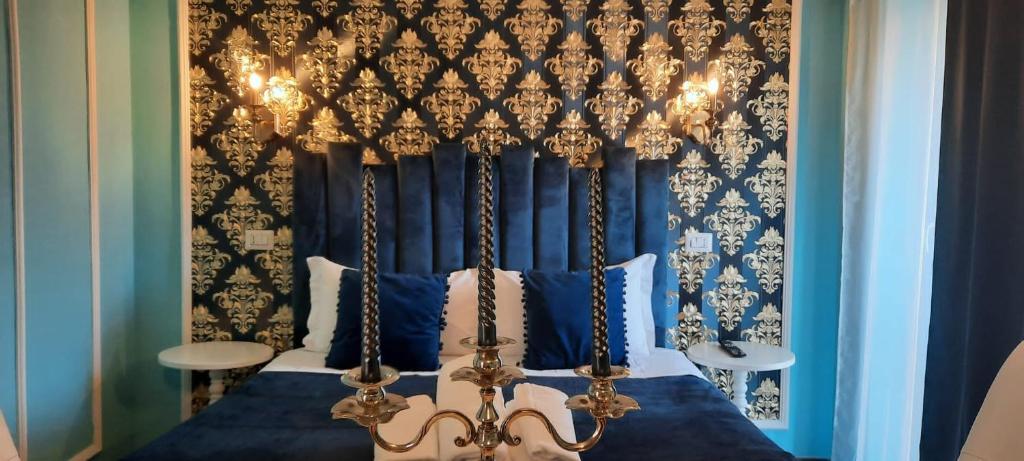 a bedroom with a canopy bed with a blue wall at Hotel magnolia 1000 mt dal casello in Valmontone