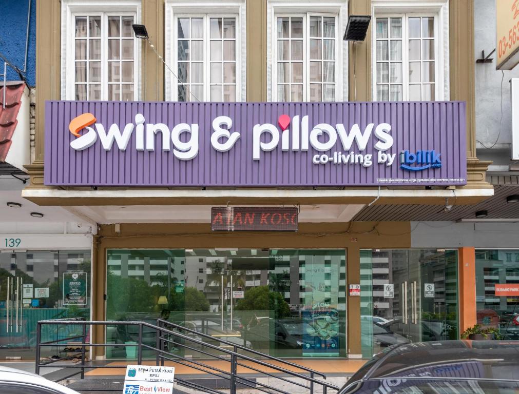 a sign for a winning and pillows store on a building at Swing & Pillows - Subang SS15 in Subang Jaya