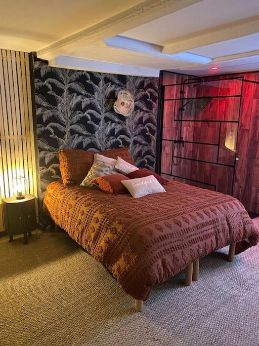 a bedroom with a bed with a red head board at BEAUTIFUL LIFE BED and SPA in Mirecourt