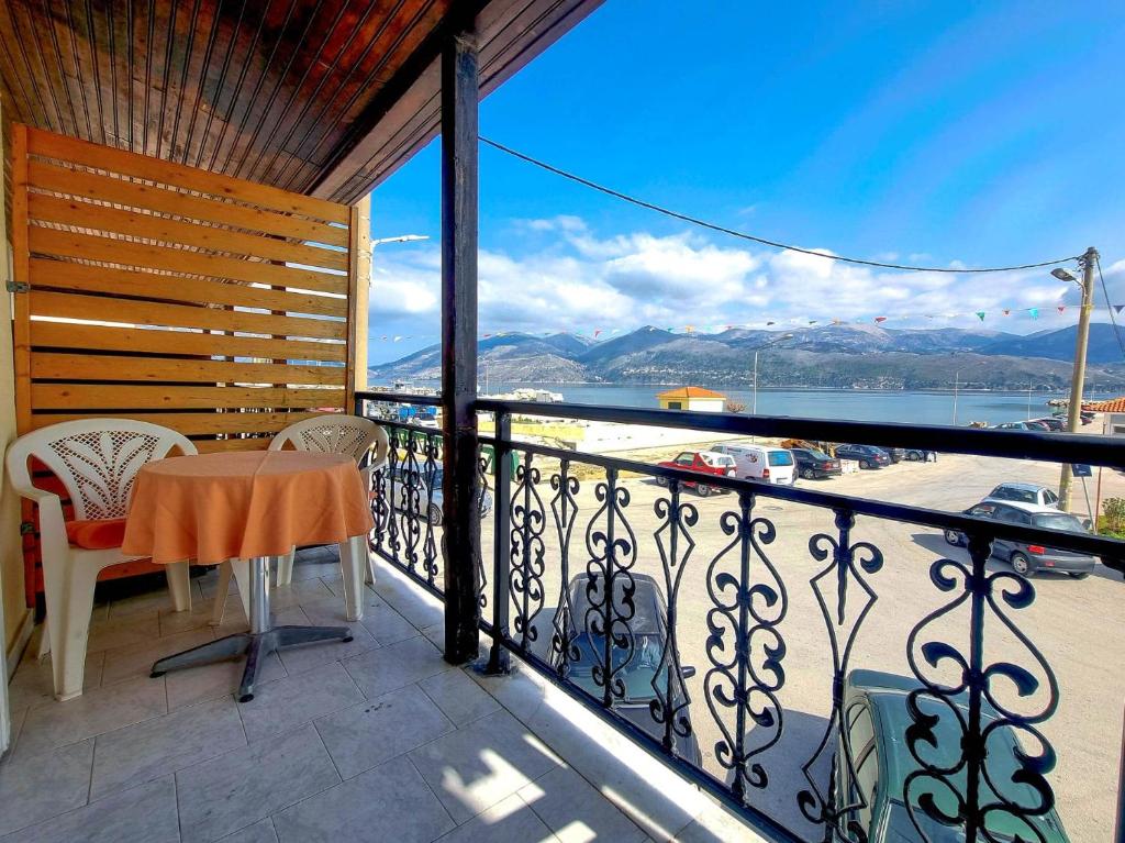 a balcony with a table and chairs and a view at "Sun" Bayview apartment in Lixouri