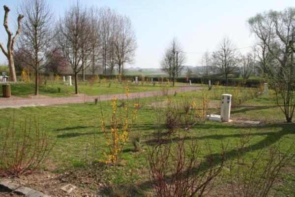 a park with a fence and a field with trees at Les Insolites du vélodrome d&#39;Albert in Albert
