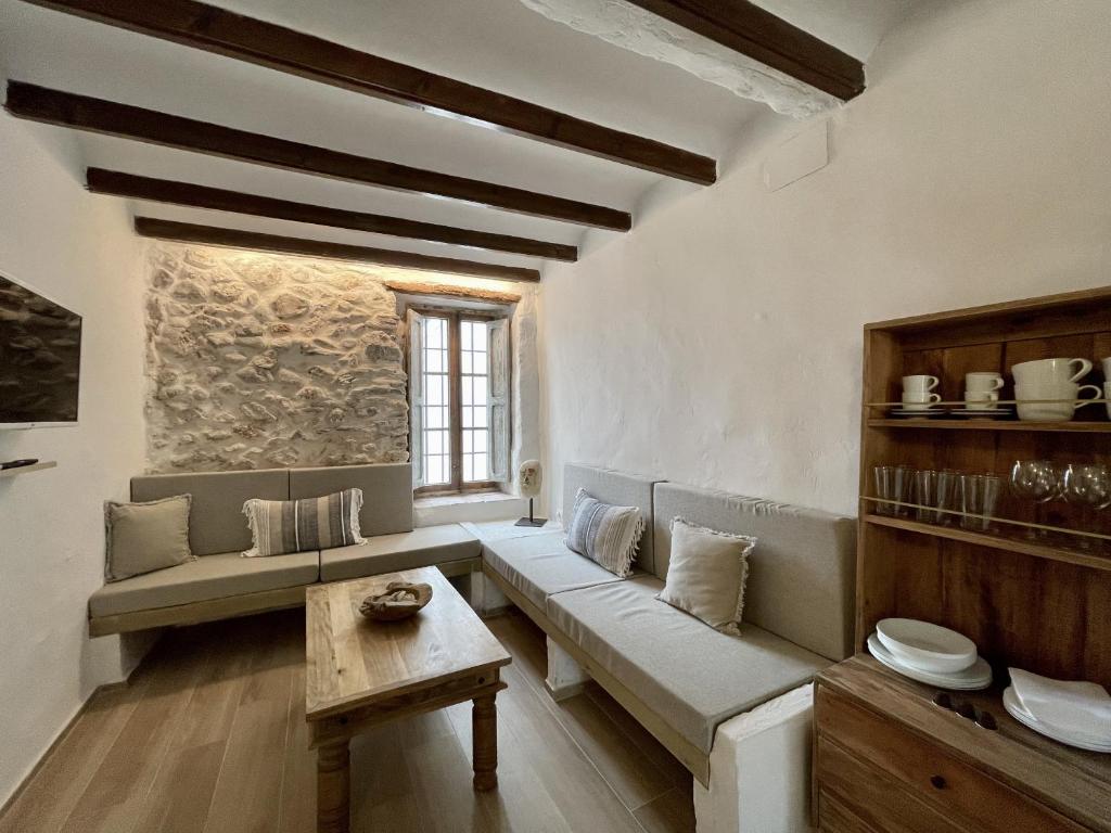 a living room with a couch and a table at Casa en el Puerto de Denia in Denia