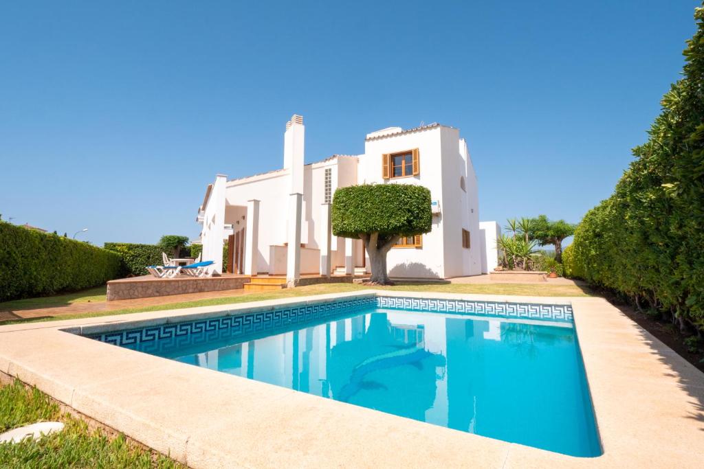 a villa with a swimming pool in front of a house at Casa Felix in Palma de Mallorca