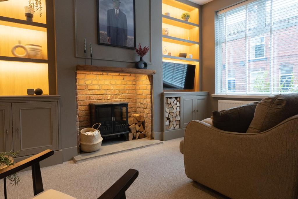 a living room with a fireplace and a couch at The Willows in Newton-le-Willows