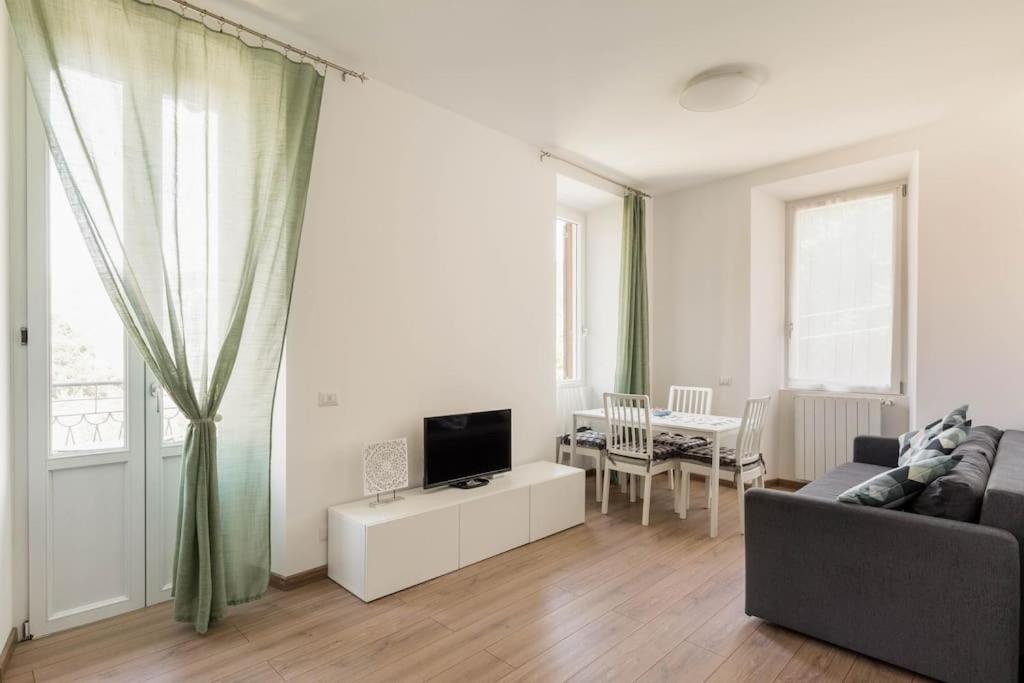 a living room with a couch and a tv at Garibaldi's Apartment in Como