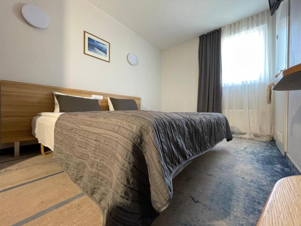 Postel nebo postele na pokoji v ubytování Green Vilnius Hotel