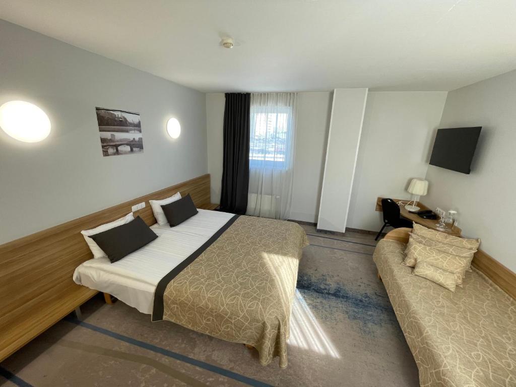 Postel nebo postele na pokoji v ubytování Green Vilnius Hotel
