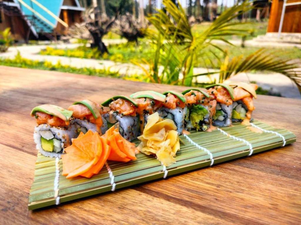 a plate of sushi on top of a wooden table at Nsaho resort in Fort Portal