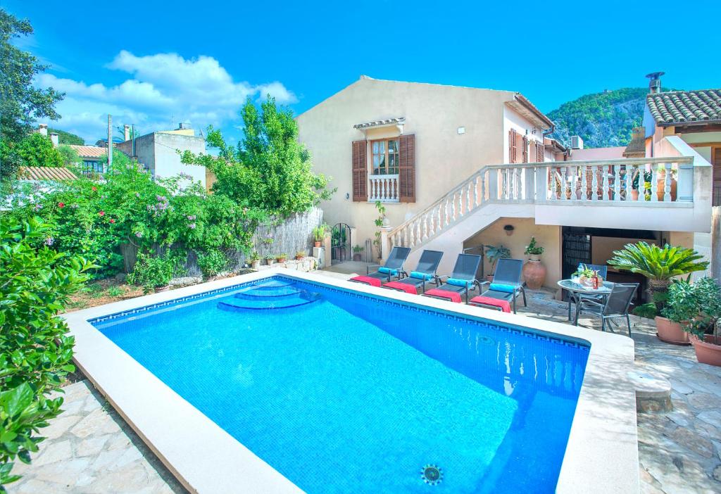 a swimming pool in front of a house at Owl Booking Villa Irina - 2 Min Walk To The Old Town in Pollença