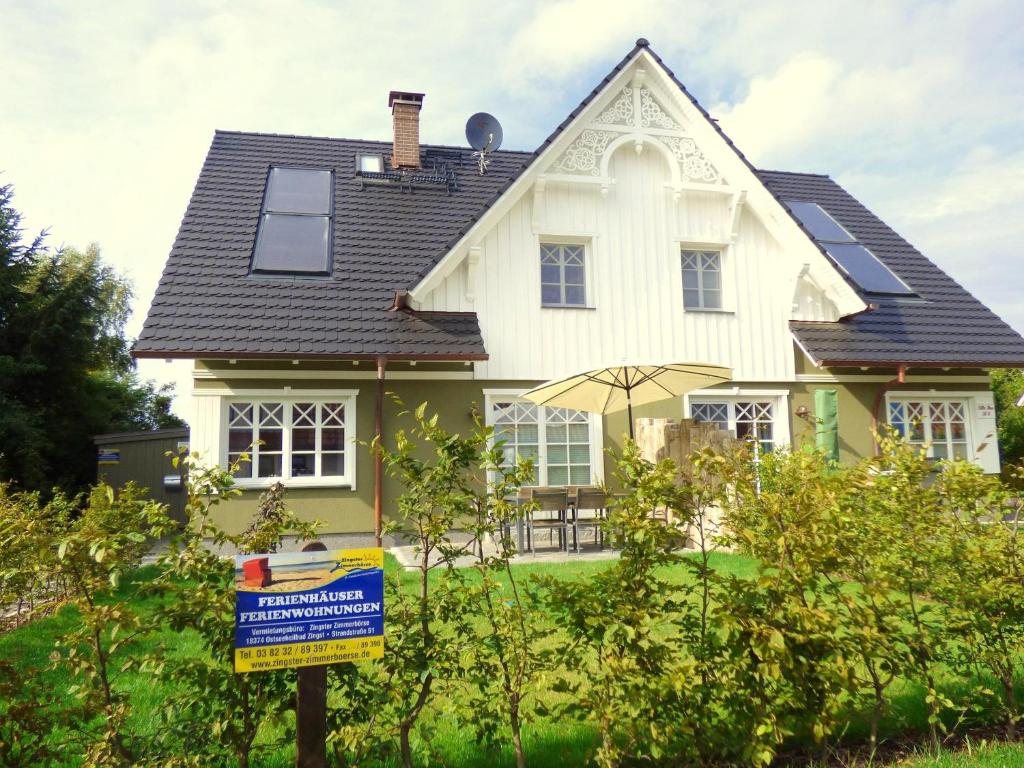 a house with a for sale sign in front of it at Lindenstrasse Haus Sonnenrose in Zingst