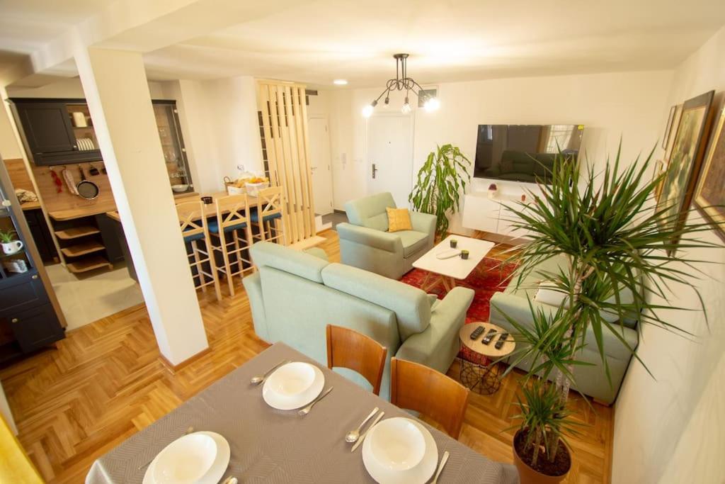 a living room with a blue couch and a table at Spacious, central and luxury flat with great view! in Novi Sad