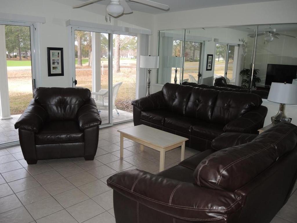 a living room with two leather couches and a coffee table at Close to Beach Brunswick Plantation Condo 2302M with 27 Hole Golf Course Onsite condo in Calabash