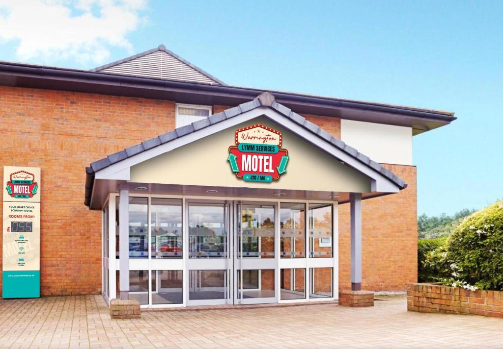 a building with a motel sign on it at Warrington Motel, J20 M6 Lymm Services in Warrington