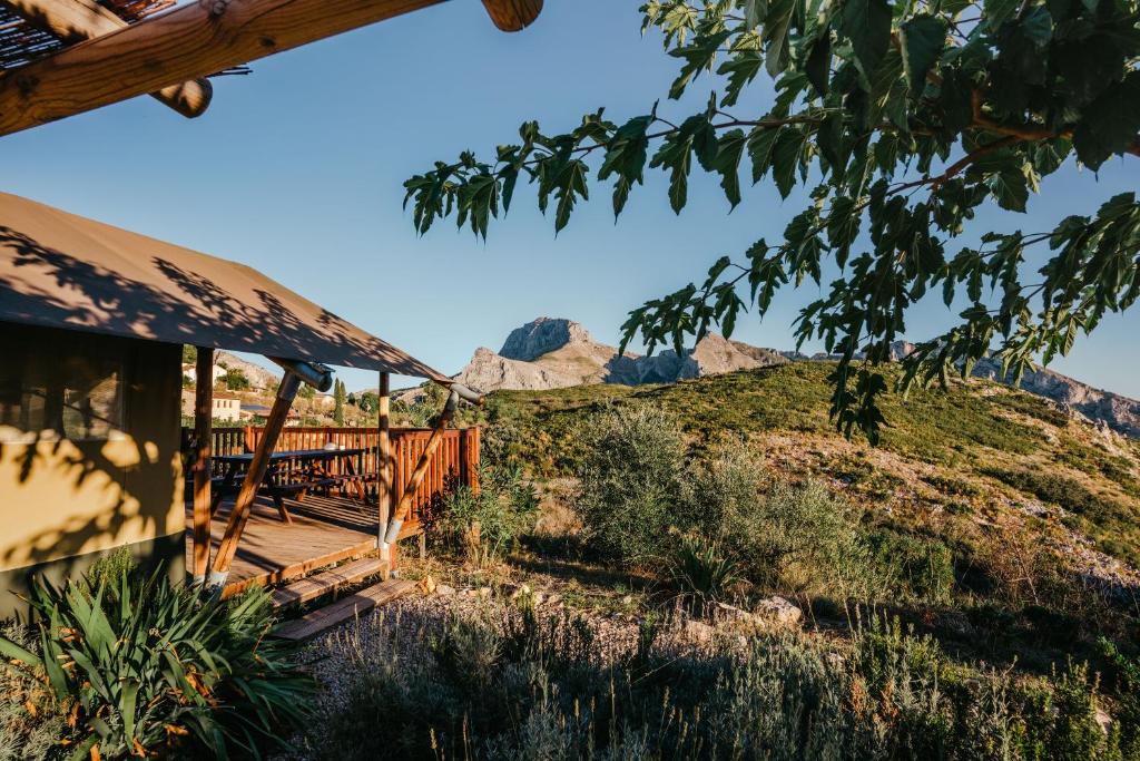 a porch of a house with mountains in the background at Can Elisa Safari Tent in Tárbena