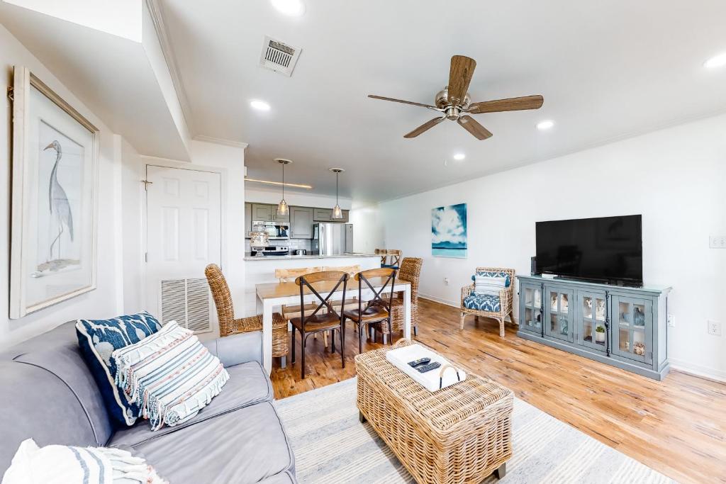 a living room with a couch and a table at A Wave From It All - Unit B in Gulf Shores