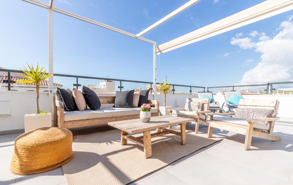 una terraza en la azotea con muebles y vistas al océano. en Penthouse Casamora, en Moraira