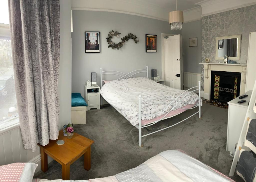 um quarto com uma cama e uma lareira em Turret Corner, Colwyn Bay, 5min walk to sandy beach em Conwy