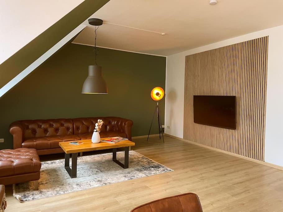 a living room with a couch and a table at Altstadt-Wohnung im Weidener Zentrum in Weiden