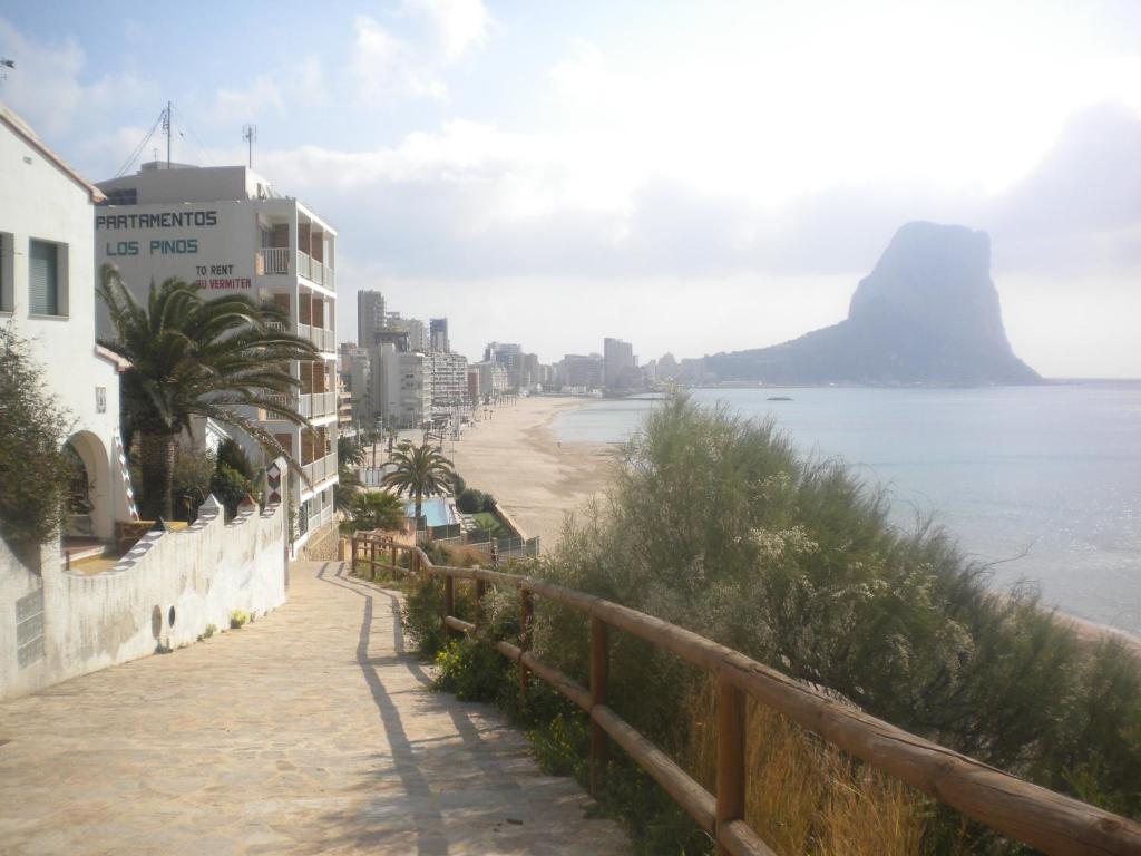 a view of a beach with a mountain in the background at Apartamentos Los Pinos in Calpe