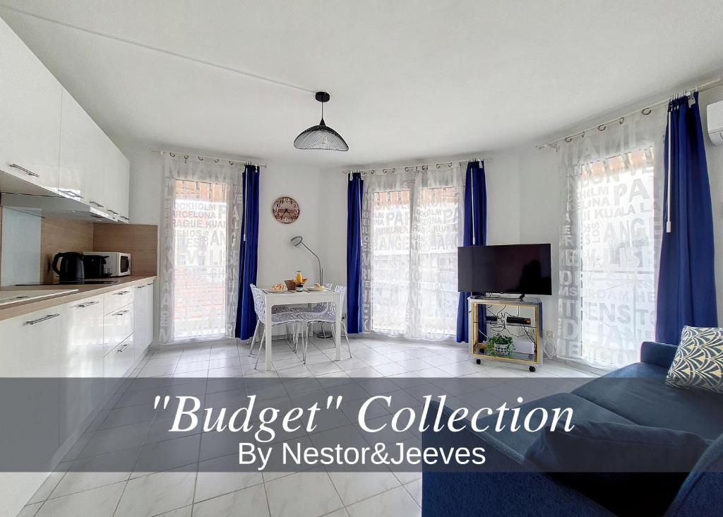 a living room with a blue couch and a kitchen at Nestor&Jeeves - VANINA - Central - Close sea in Nice
