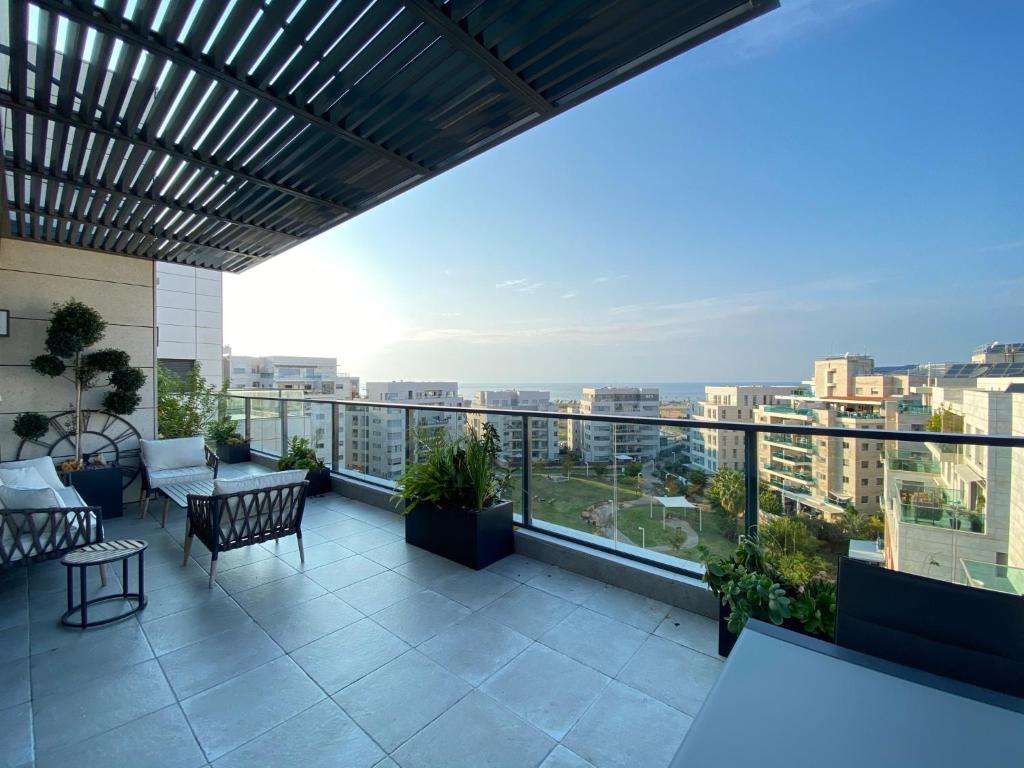 a balcony with a view of a city at Tlv sea view penthouse in Tel Aviv