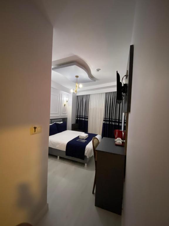 a hotel room with a bed and a desk and a bedroom at Ramos Boutique Hotel Sultanahmet in Istanbul