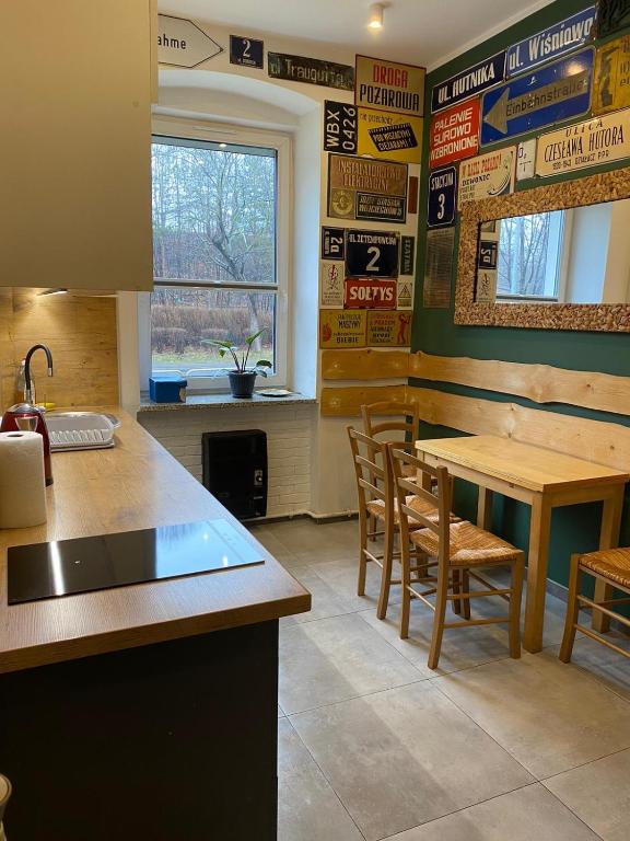 a kitchen with a table and chairs in a restaurant at Apartament Wrocławska blisko zamku Książ in Wałbrzych
