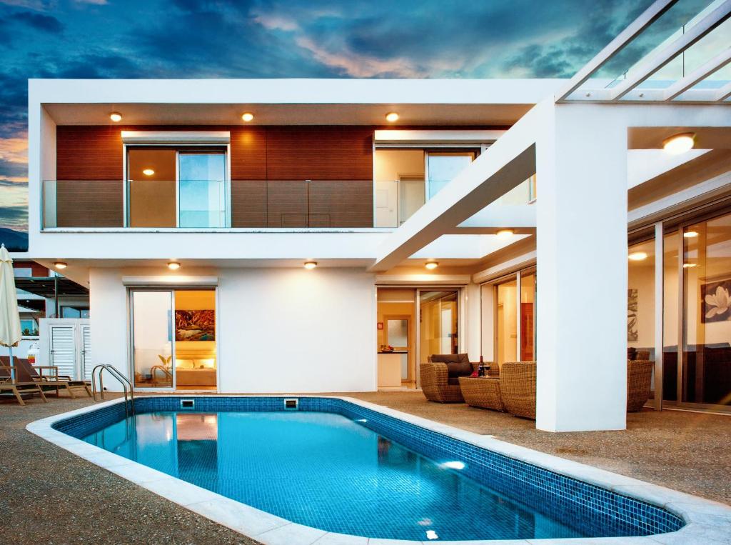 a house with a swimming pool in front of a house at Villa Rubi in Ayia Napa