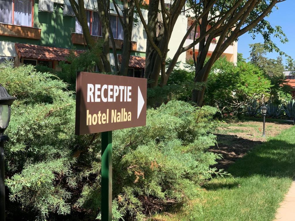 a sign for a hotel in front of a building at Hotel Nalba Jupiter in Jupiter