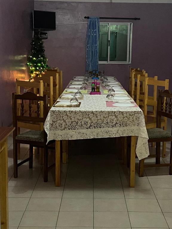 a dining room table with chairs and a christmas tree at Casa Ze & sonia in Portela