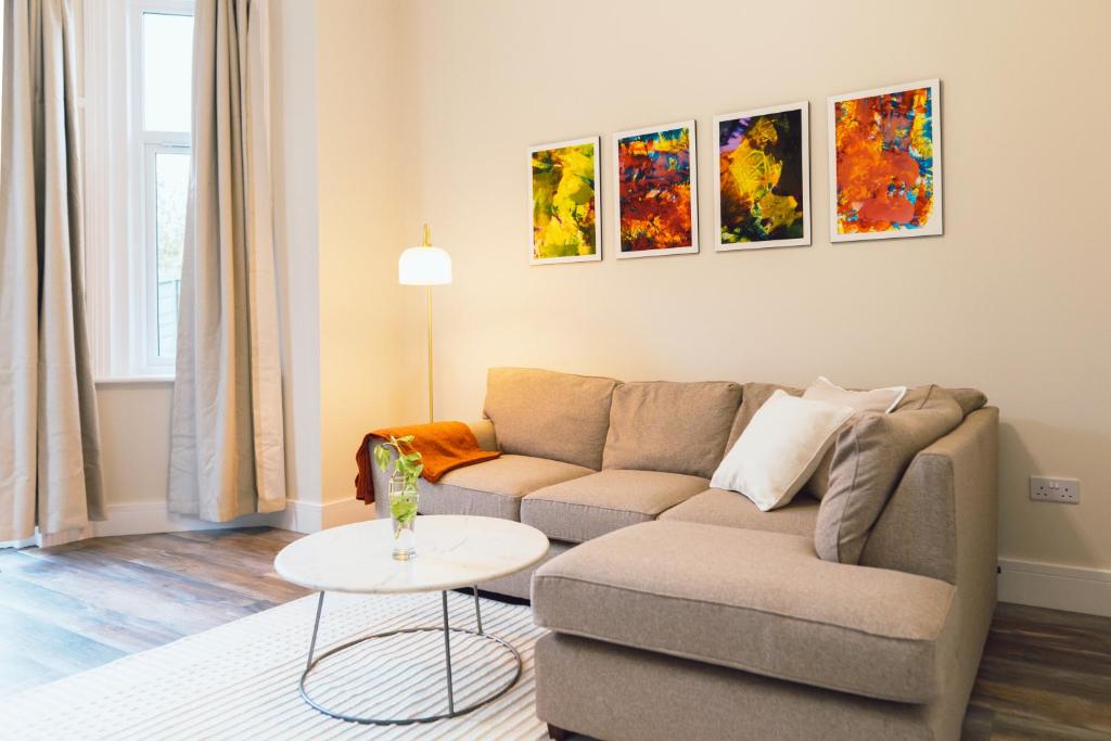 a living room with a couch and a table at The Milkmans Residence in Bournemouth