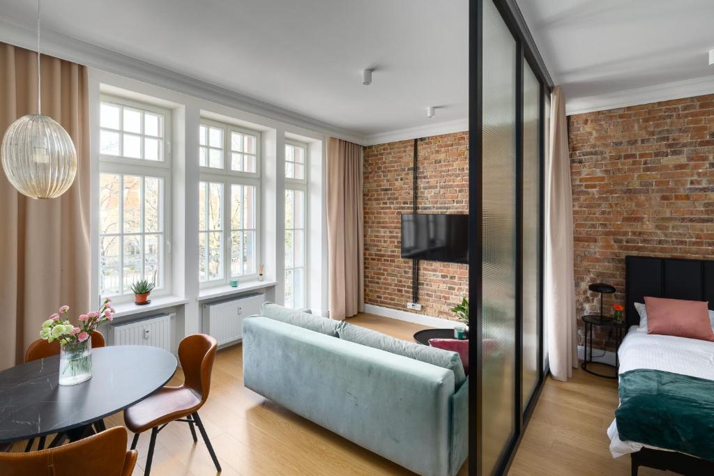 a living room with a couch and a table at Apartament Aleja 22 in Poznań