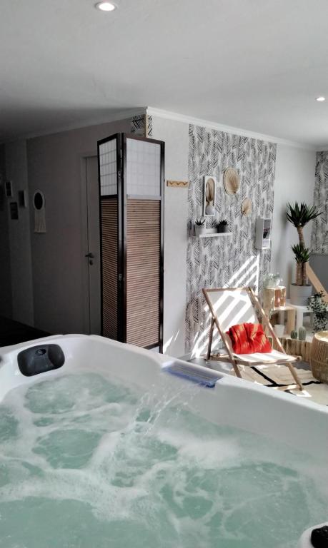 a bath tub filled with water in a bathroom at Au bord de la Moselle in Ramonchamp