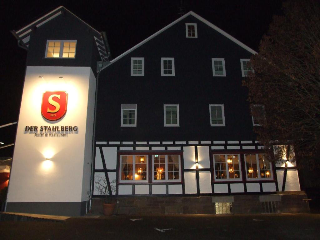 a large black building with a s sign in front of it at Der Stahlberg Hotel & Restaurant in Hilchenbach