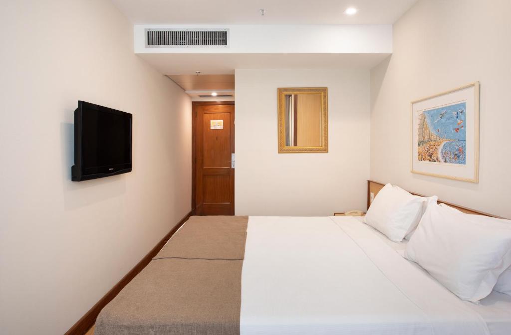 Кровать или кровати в номере Windsor Plaza Copacabana
