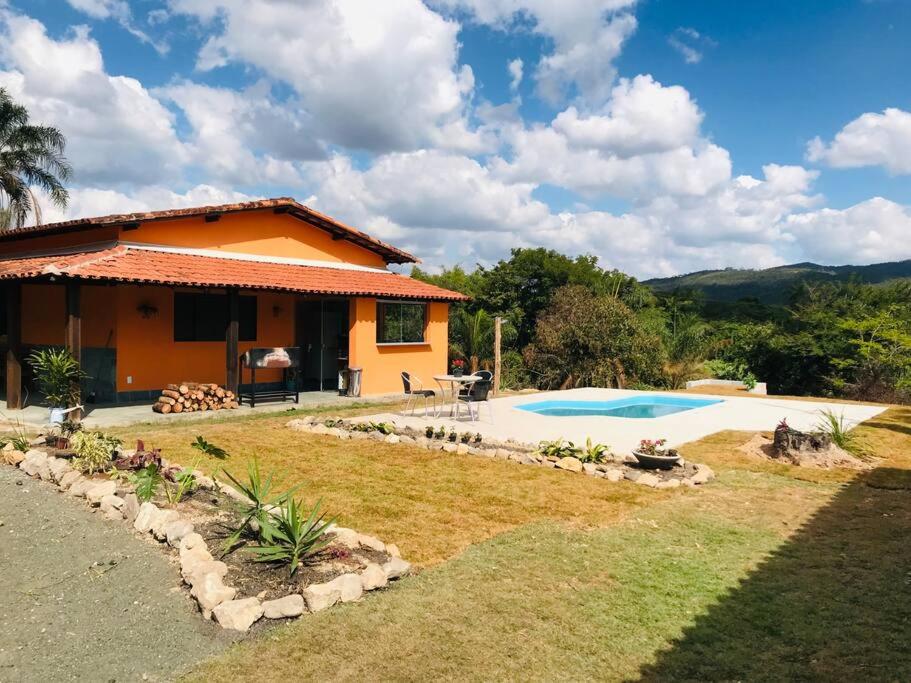 a house with a swimming pool in front of it at Fazenda Santa Amalia 