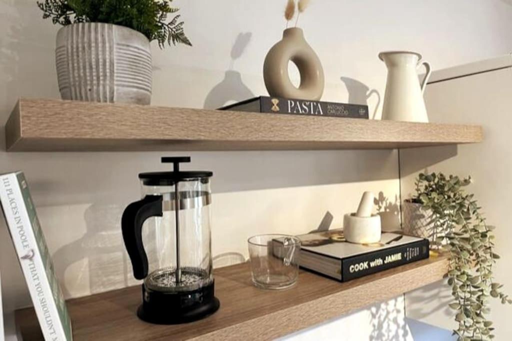 a shelf with a blender and other items on it at The Nook - Cosy coastal retreat near Sandbanks in Poole