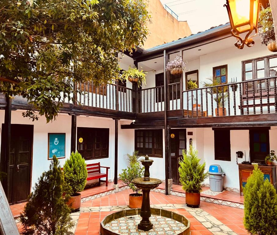 a courtyard with a fountain in front of a building at Casa Aranjuez in Bogotá