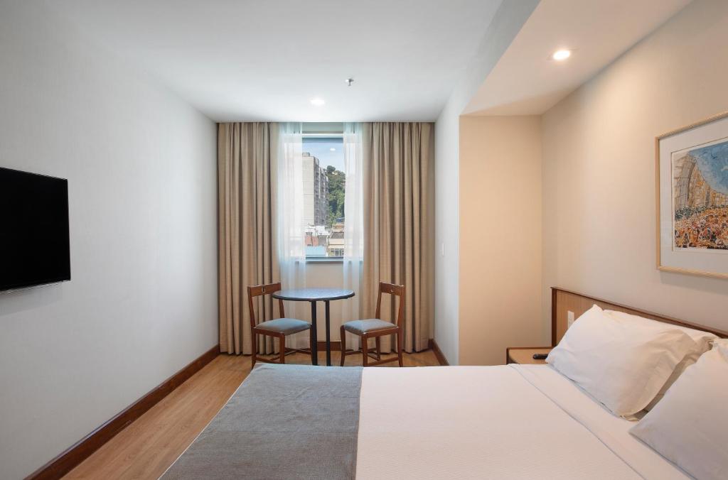 Кровать или кровати в номере Windsor Plaza Copacabana