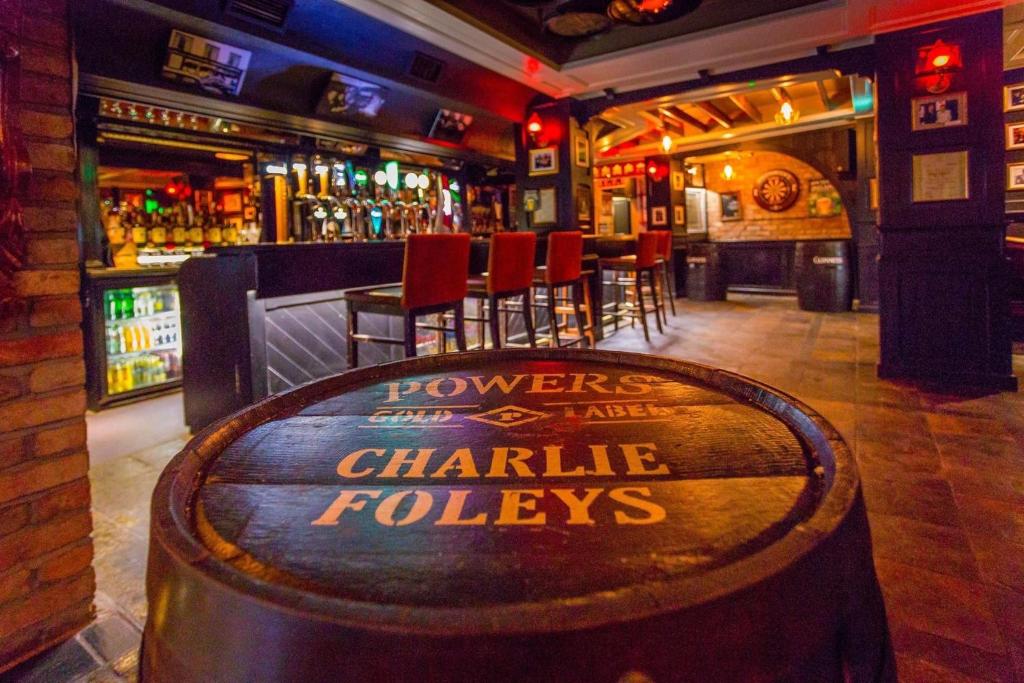 a bar with a wooden barrel in the middle of a bar at Charlie Foleys in Killarney
