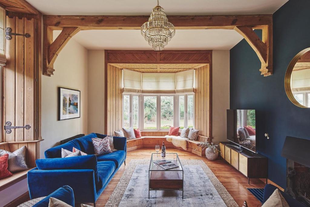 a living room with a blue couch and a table at The Old Vicarage in Holmrook